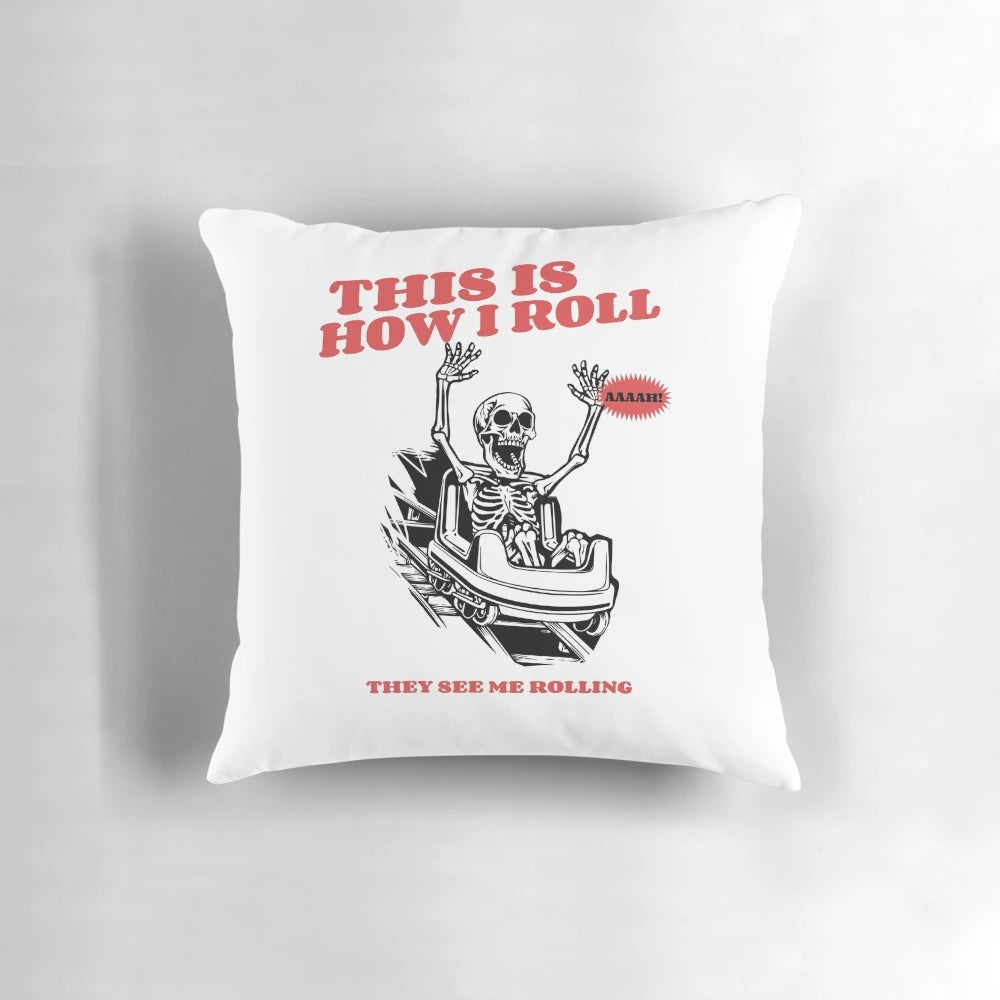 Decorative pillow with a skeleton riding a roller coaster design, featuring a "This Is How I Roll" statement.