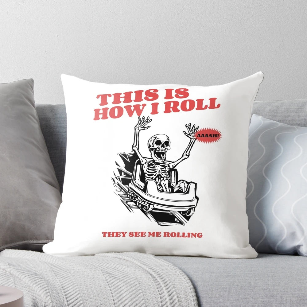 Decorative pillow with a skeleton riding a roller coaster design, featuring a "This Is How I Roll" statement.