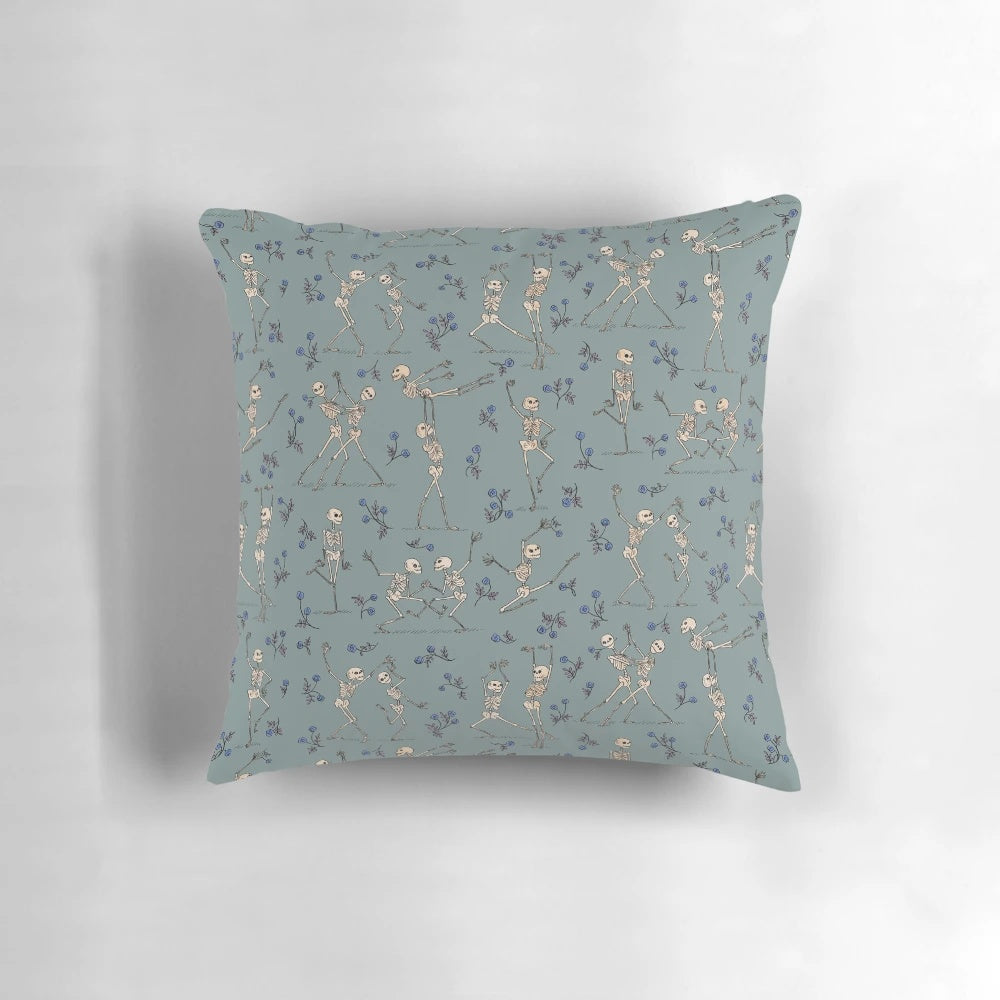 Blue decorative pillow featuring a dancing skeleton design, perfect for Halloween home decor.