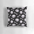 Soft, cozy pillow featuring a repeating pattern of cute, minimalist skulls in shades of black and white.