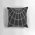 A decorative black and white spider web printed pillow for gothic or Halloween-themed home decor.