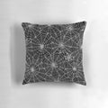 A black and white pillow featuring a detailed spider web pattern, perfect for Halloween and horror-themed decor.