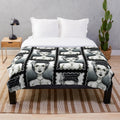 A plush blanket featuring a vintage-inspired black and white illustration of the Bride of Frankenstein character.