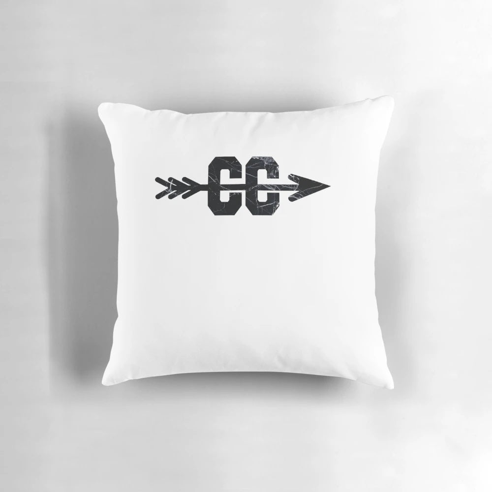 A stylish marble-patterned pillow featuring a crossed-flag cross country logo, perfect for runners and sports enthusiasts.