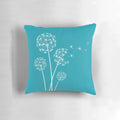 Dark turquoise dandelion flower pillow with soft, fluffy petals and seeds blowing in the wind