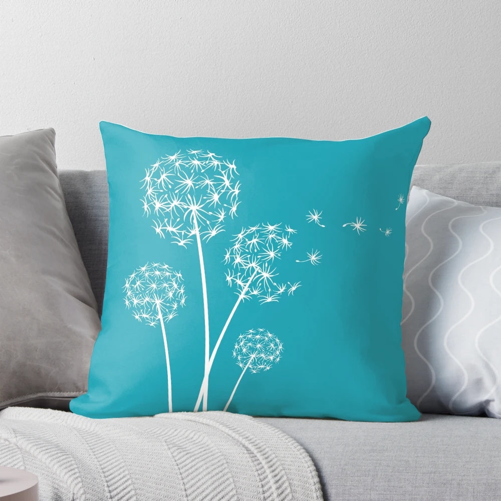 Dark turquoise dandelion flower pillow with soft, fluffy petals and seeds blowing in the wind