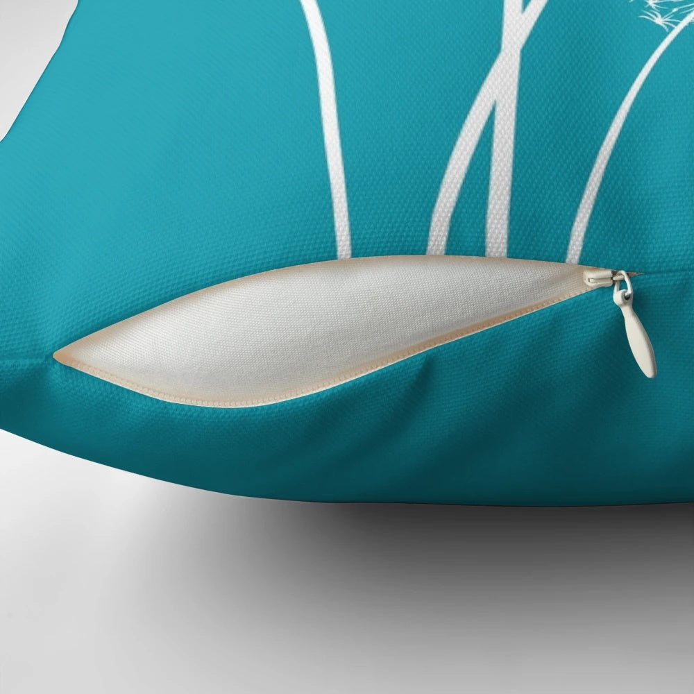 Dark turquoise dandelion flower pillow with soft, fluffy petals and seeds blowing in the wind