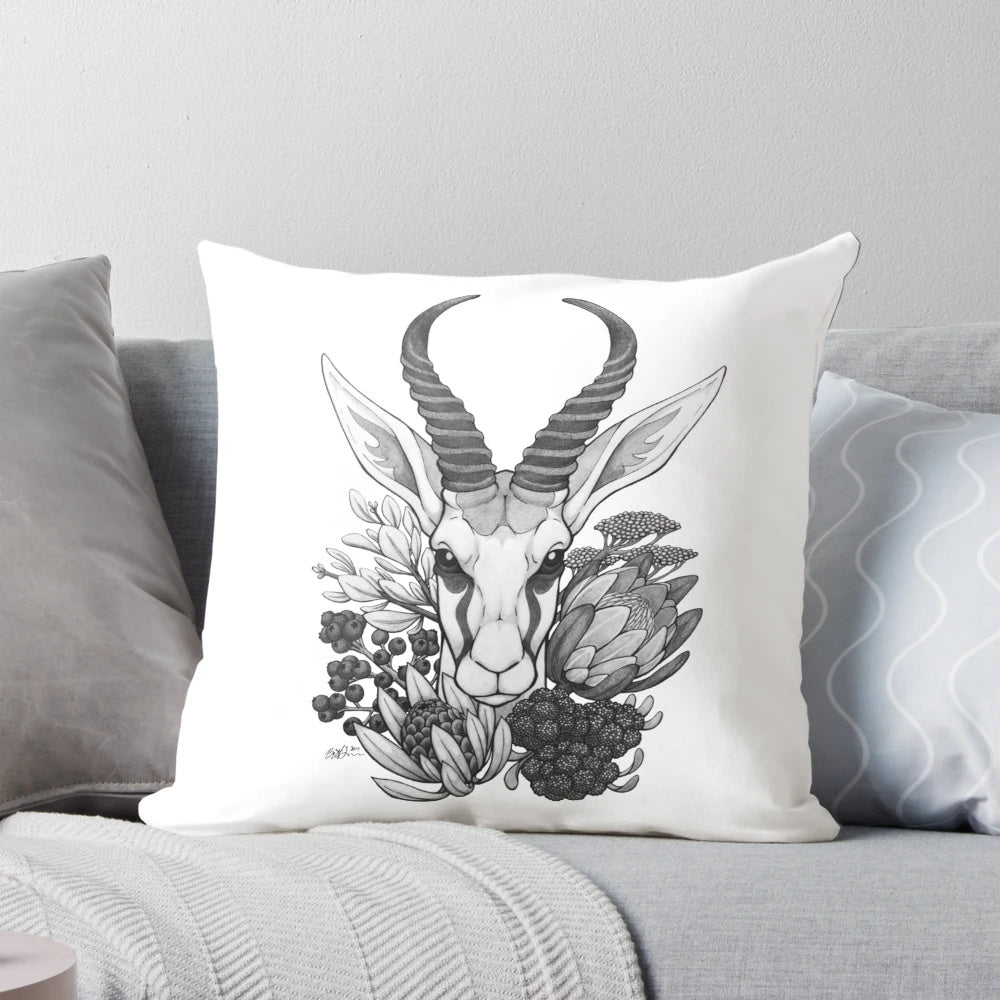 A black and white throw pillow featuring the silhouette of a springbok antelope surrounded by fynbos flowers, perfect for South African-inspired home decor.