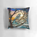 A stained glass-inspired decorative pillow featuring a winter landscape with hills, trees, and a sunrise.