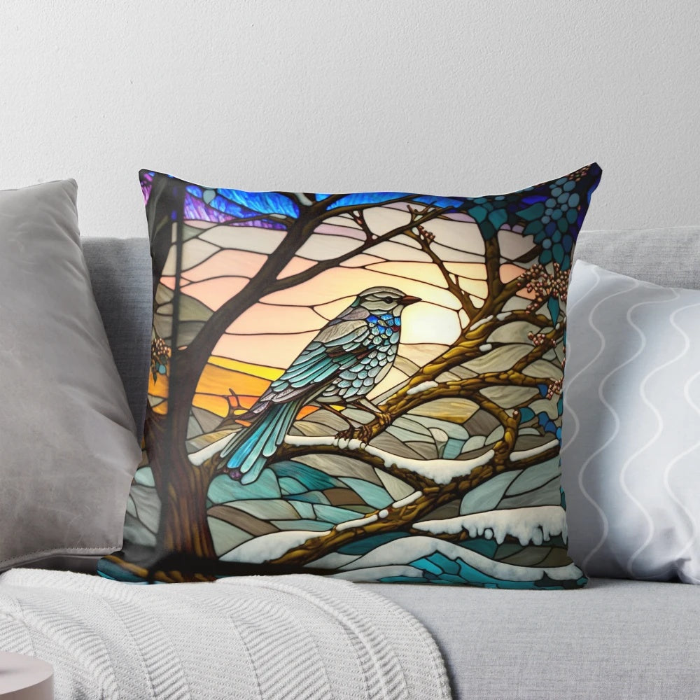 A stained glass-inspired decorative pillow featuring a winter landscape with hills, trees, and a sunrise.