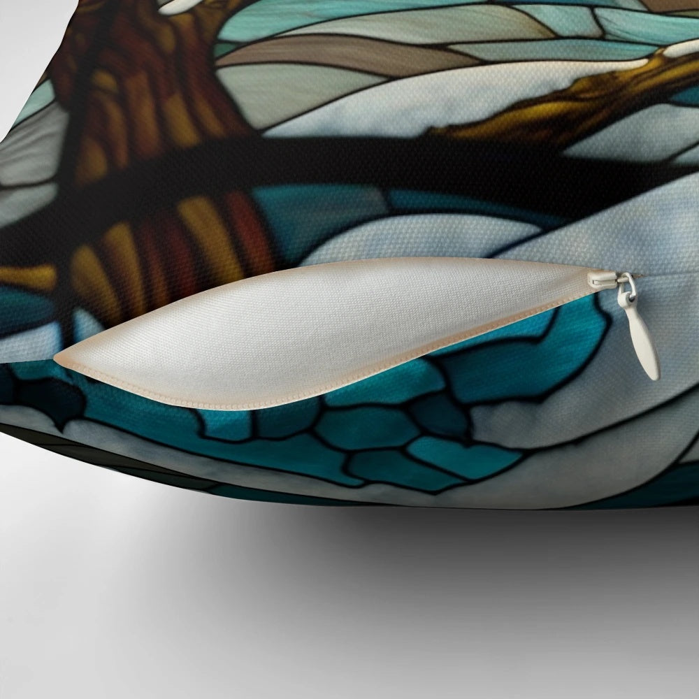 A stained glass-inspired decorative pillow featuring a winter landscape with hills, trees, and a sunrise.