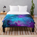 Starry galaxy plush blanket with purple, blue and cosmic design