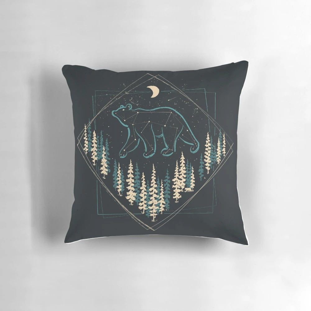 A soft, plush pillow featuring a bear under a starry night sky
