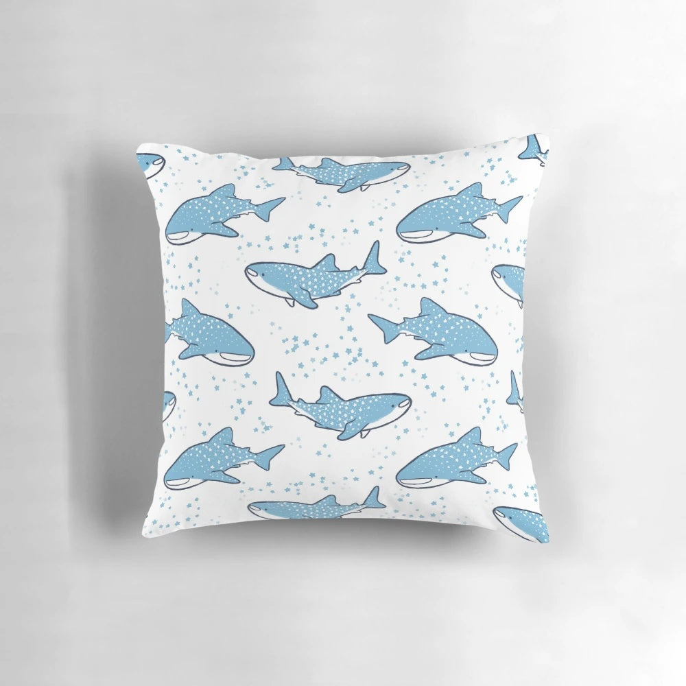 A decorative throw pillow featuring a cute cartoon whale shark swimming against a starry night sky background