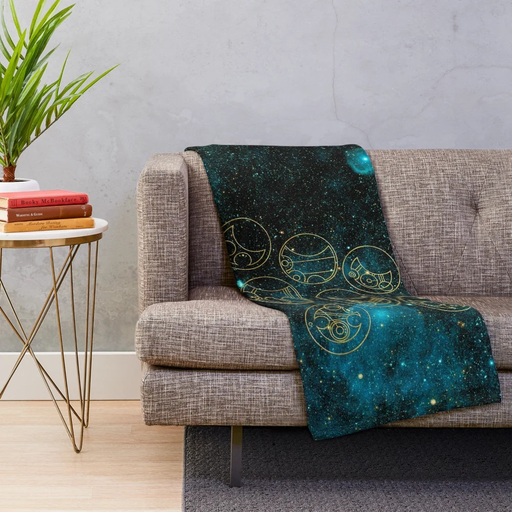 Plush blanket with time lord words in gold on a teal stellar background