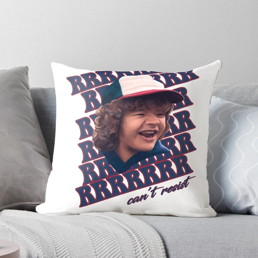 A cozy pillow featuring the character Dustin from the Netflix series Stranger Things, with the caption "Can't resist those pearls."