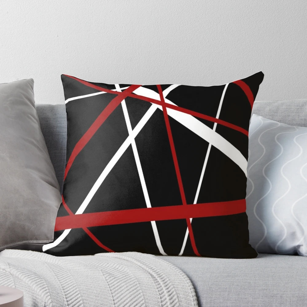 Pillow featuring a bold, abstract pattern of intersecting red and white lines on a black background.