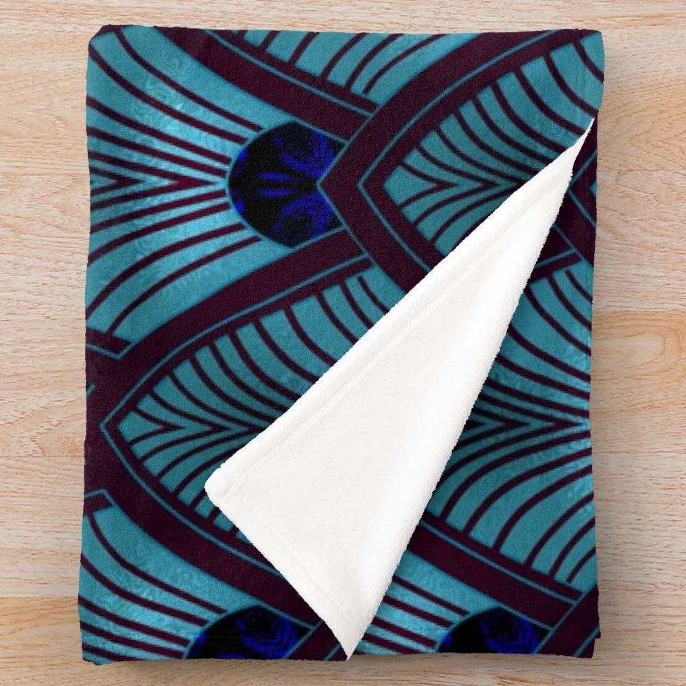 Stylized sunburst pattern in metallic blue plush blanket