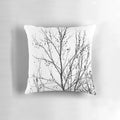 A decorative black and white pillow featuring an abstract design of bare tree branches against a neutral background, capturing the beauty of the autumn season.