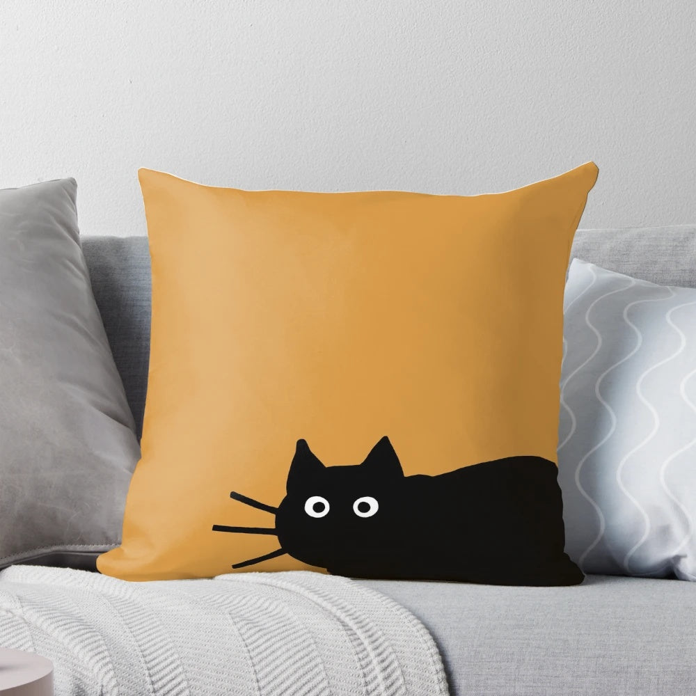 A decorative black cat-themed pillow with a fun, whimsical design.