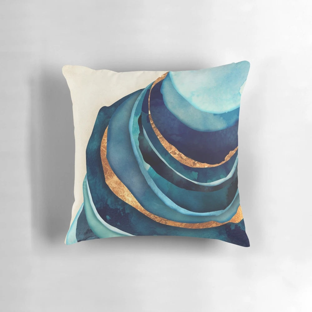 A vibrant abstract accent pillow in shades of blue and gold, creating a bold and modern design.