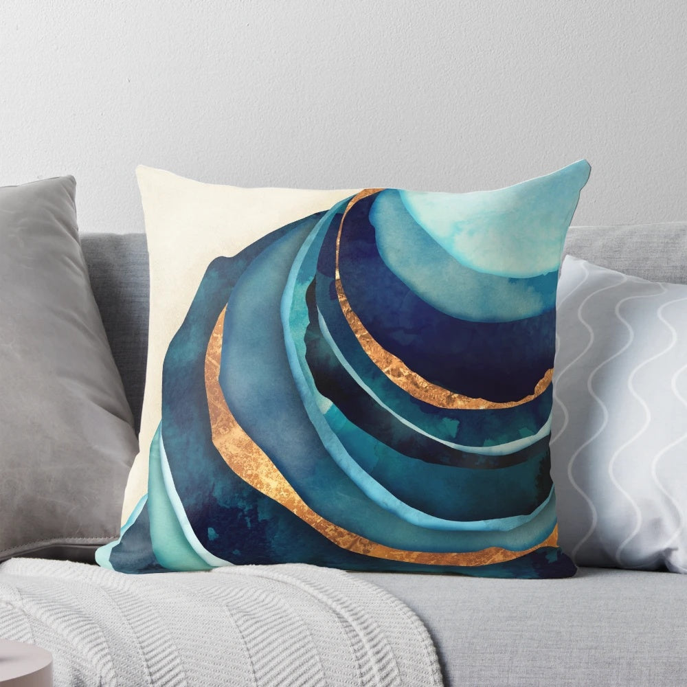 A vibrant abstract accent pillow in shades of blue and gold, creating a bold and modern design.