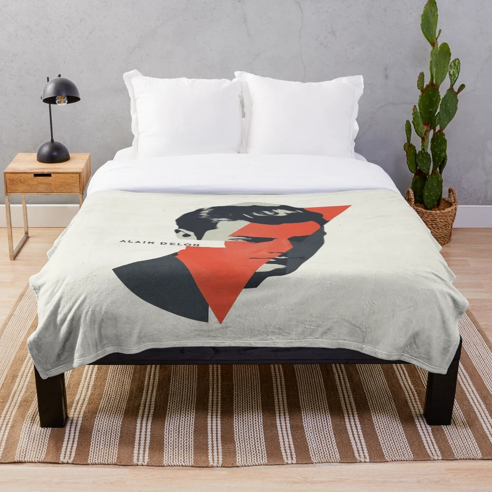 Alain Delon, French actor, in a bold geometric portrait with red accents on a plush blanket