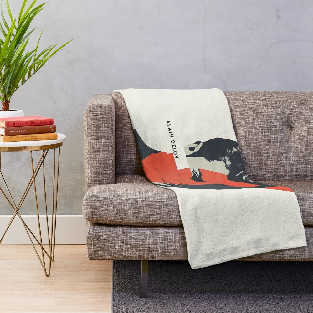 Alain Delon, French actor, in a bold geometric portrait with red accents on a plush blanket