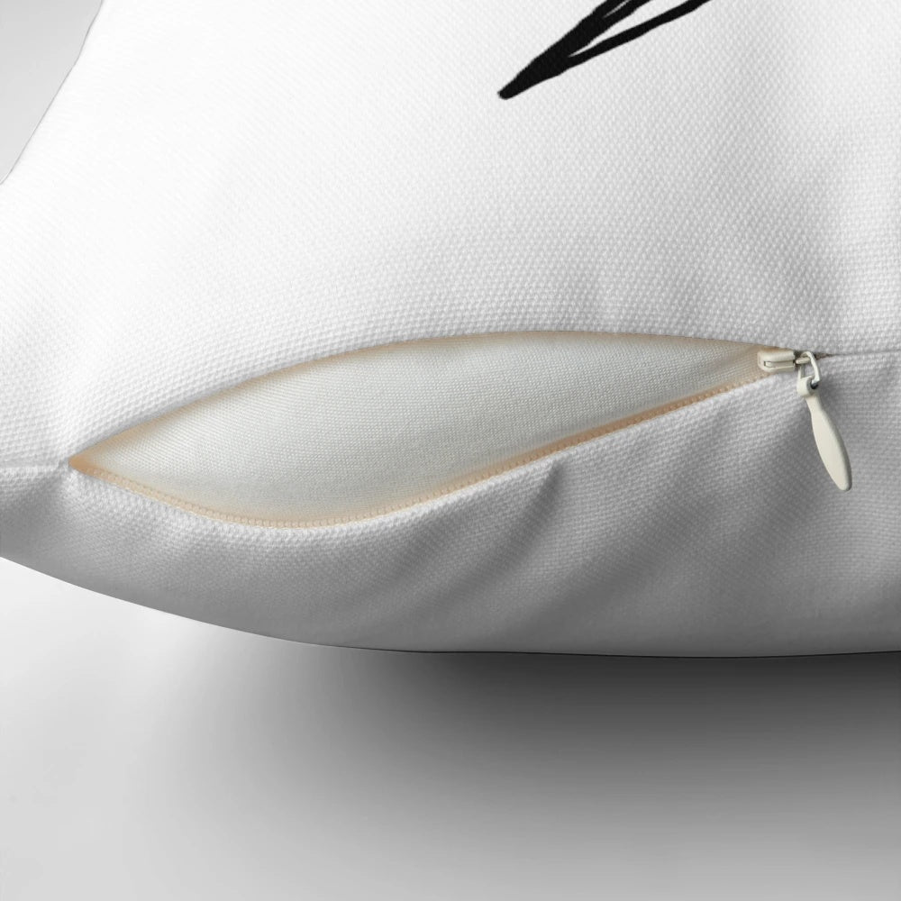 A striking black and white hand drawn lightning bolt design on a decorative throw pillow.