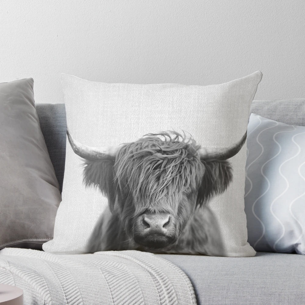 A black and white portrait illustration of a majestic Highland cow on a pillow