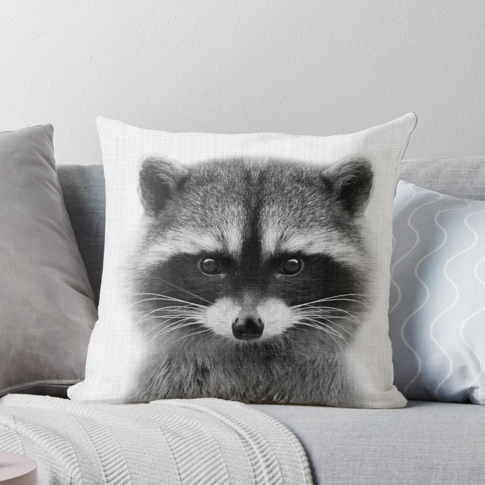 Detailed black and white photograph of a raccoon's face and shoulders against a plain background.