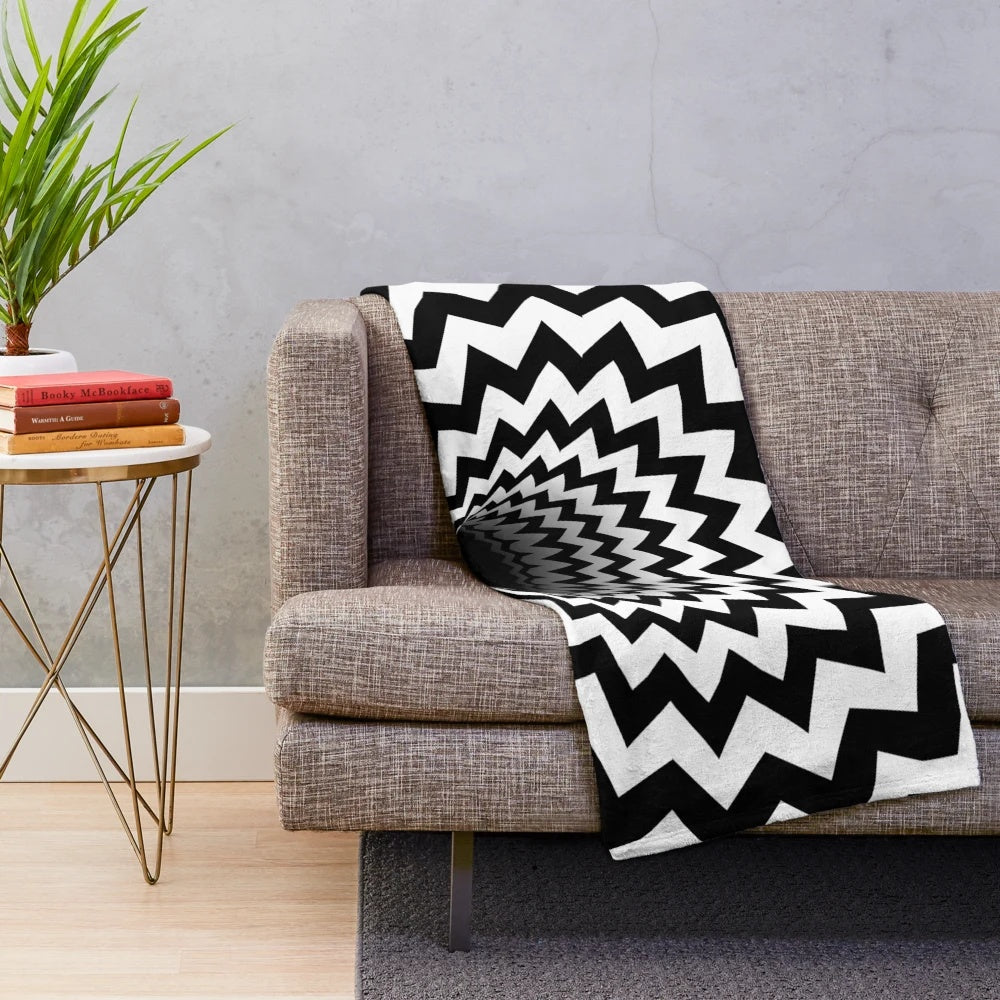Optical illusion black and white plush blanket with hypnotic chevron pattern