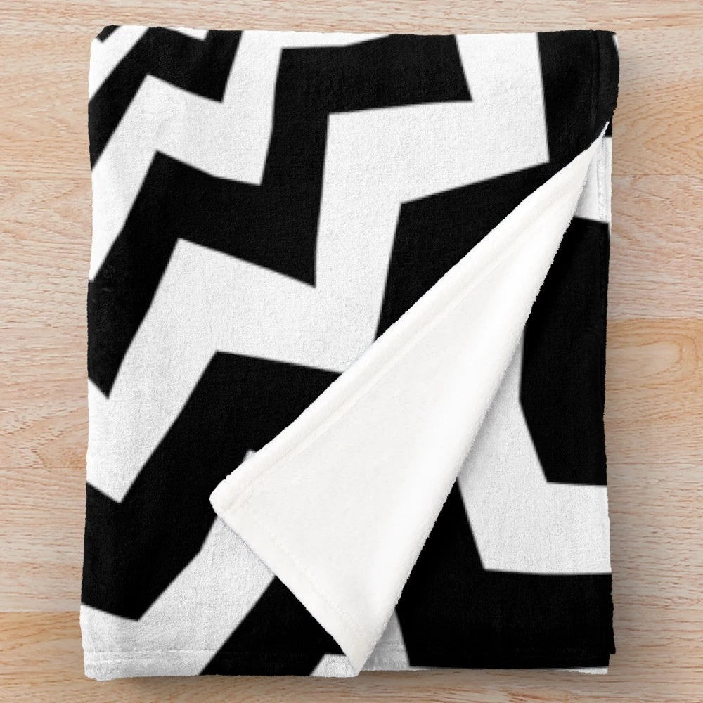 Optical illusion black and white plush blanket with hypnotic chevron pattern