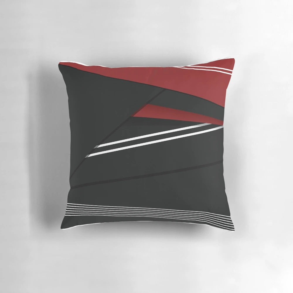 A vibrant abstract striped pillow in red, white, and black colors