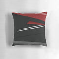 A vibrant abstract striped pillow in red, white, and black colors