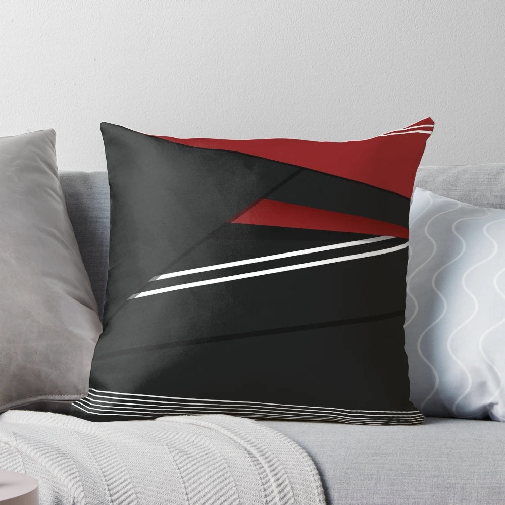 A vibrant abstract striped pillow in red, white, and black colors