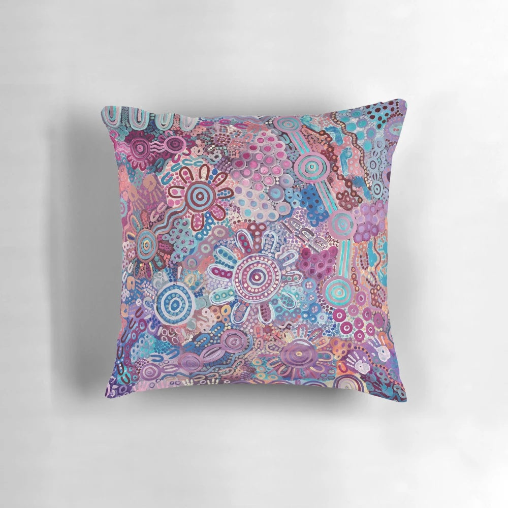 Colorful Aboriginal art pillow featuring a design that represents protecting the land and environment