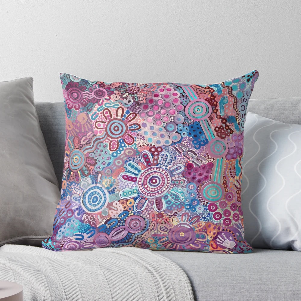 Colorful Aboriginal art pillow featuring a design that represents protecting the land and environment