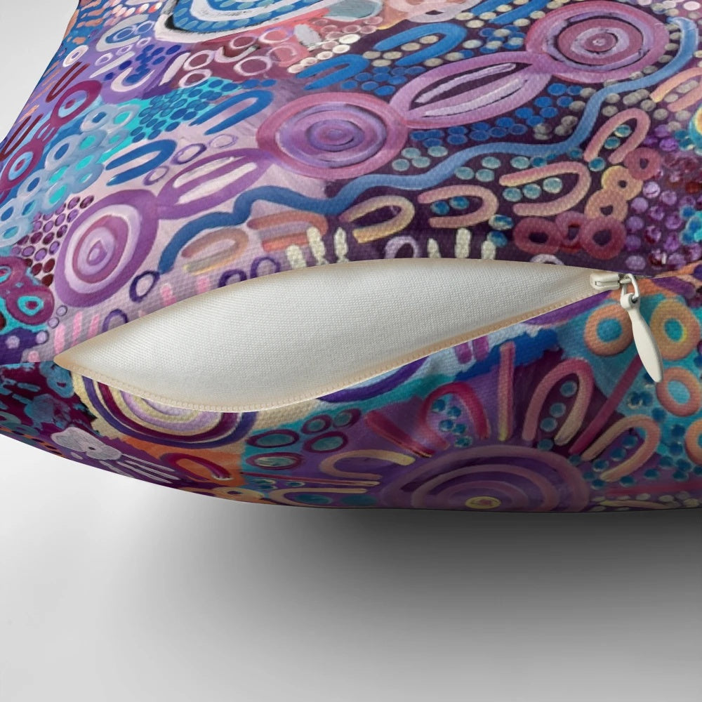 Colorful Aboriginal art pillow featuring a design that represents protecting the land and environment