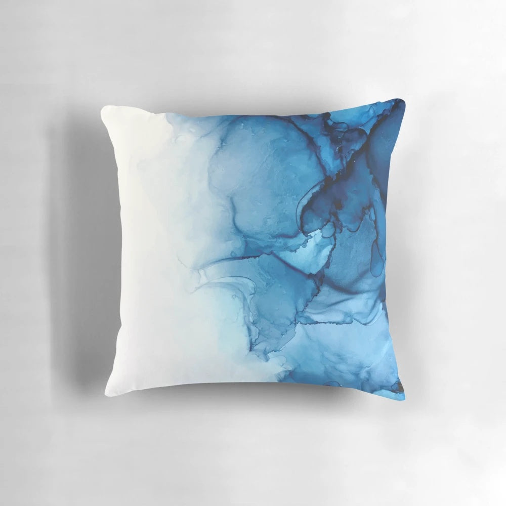 Vibrant abstract art alcohol ink painting depicting blue ocean waves on a decorative pillow