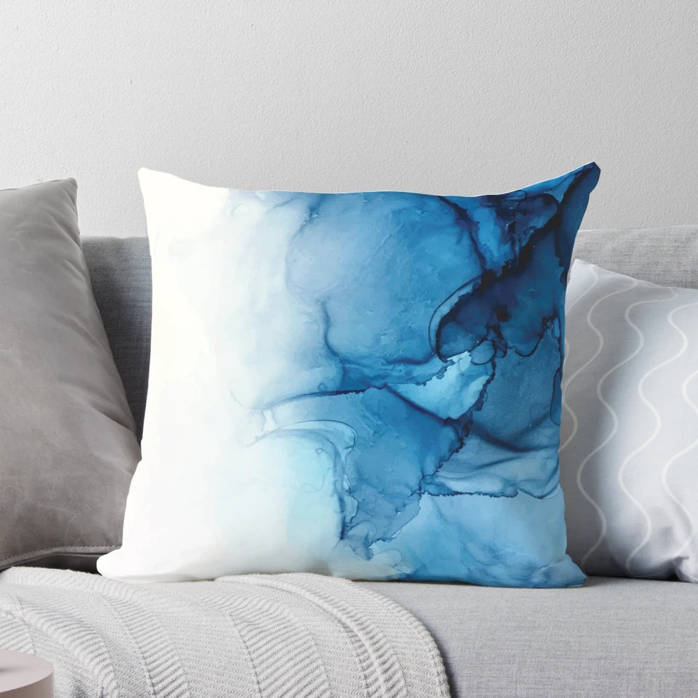 Vibrant abstract art alcohol ink painting depicting blue ocean waves on a decorative pillow