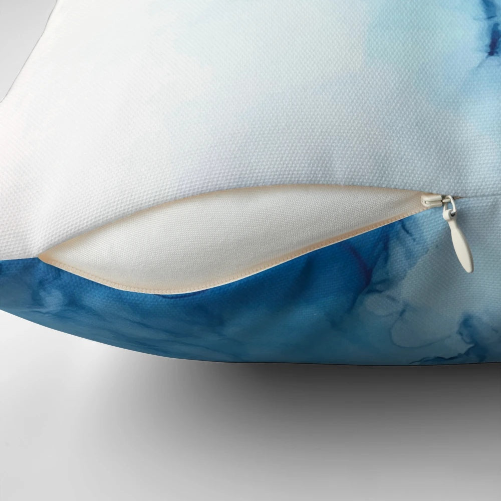 Vibrant abstract art alcohol ink painting depicting blue ocean waves on a decorative pillow