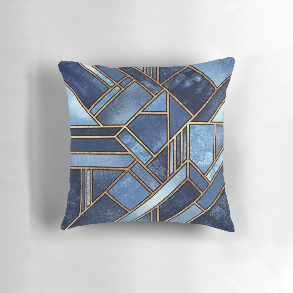 Vibrant abstract geometric pillow in shades of blue and gold with a modern mosaic pattern.