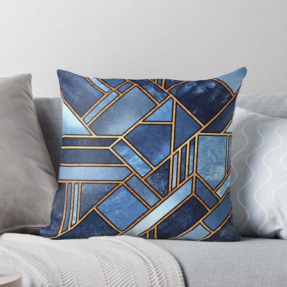 Vibrant abstract geometric pillow in shades of blue and gold with a modern mosaic pattern.