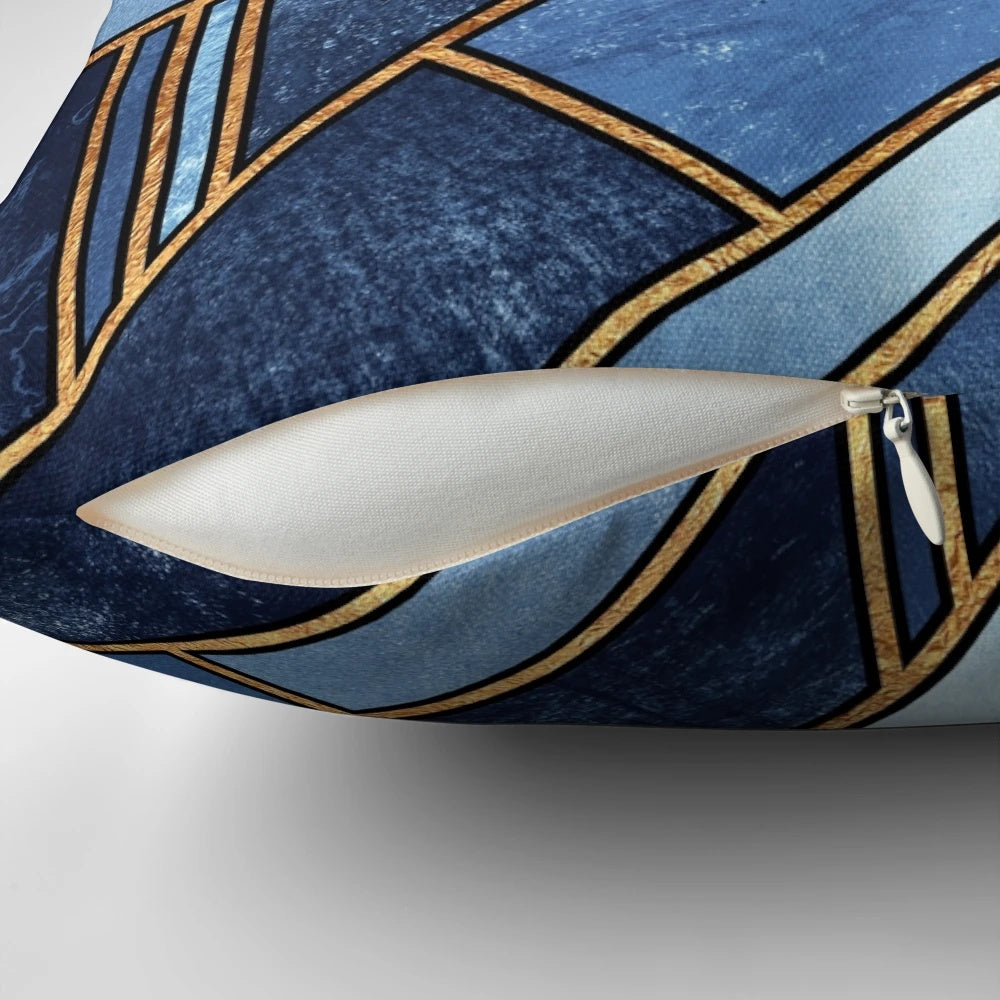 Vibrant abstract geometric pillow in shades of blue and gold with a modern mosaic pattern.