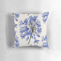 Vibrant watercolor painting of blue agapanthus flowers on a decorative pillow