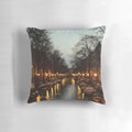 A colorful pillow depicting a scenic sunset over the iconic canals of Amsterdam, Netherlands.
