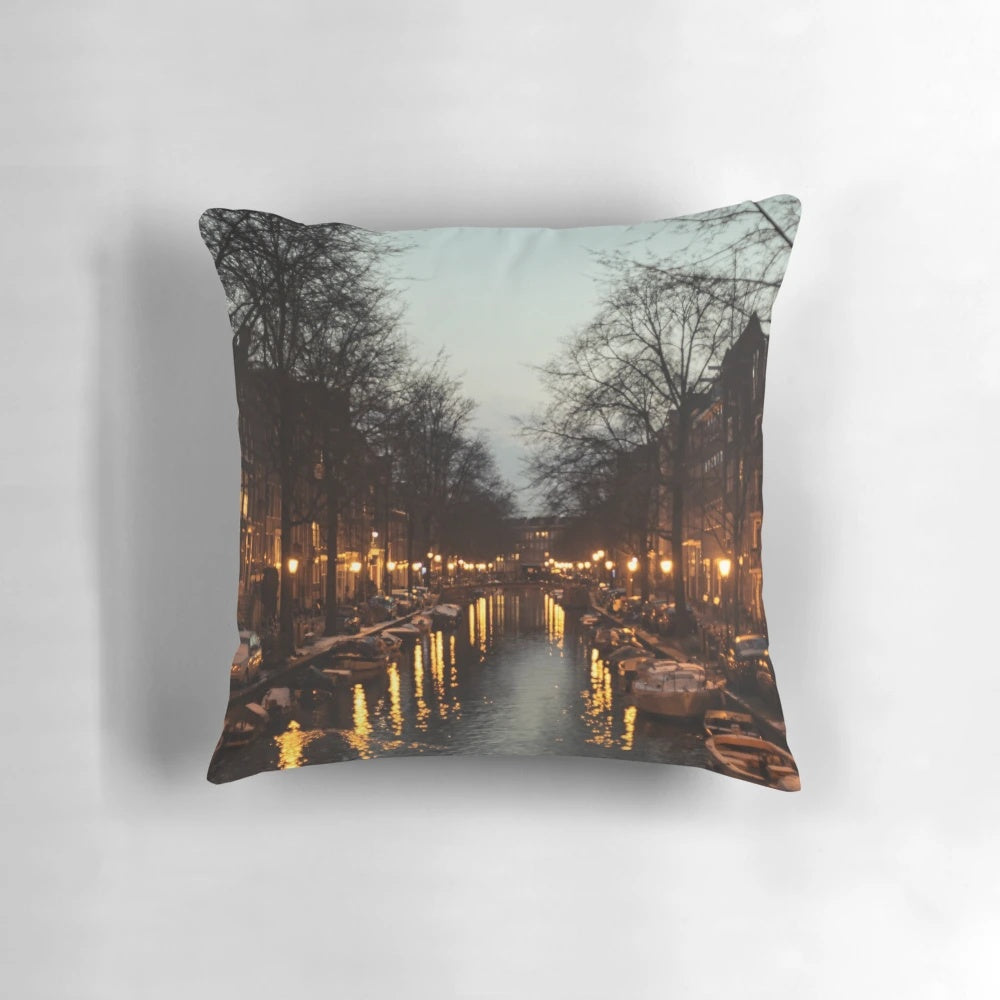 A colorful pillow depicting a scenic sunset over the iconic canals of Amsterdam, Netherlands.