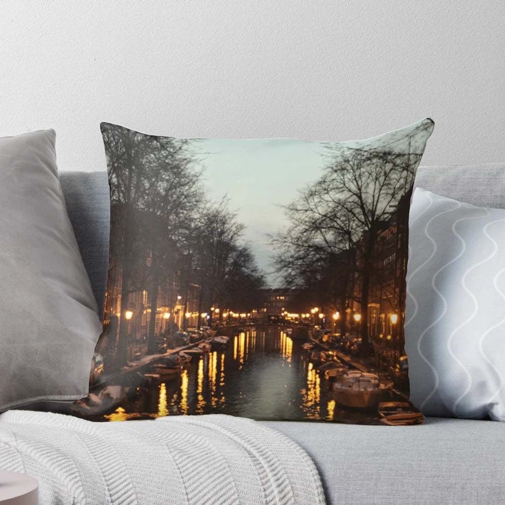 A colorful pillow depicting a scenic sunset over the iconic canals of Amsterdam, Netherlands.