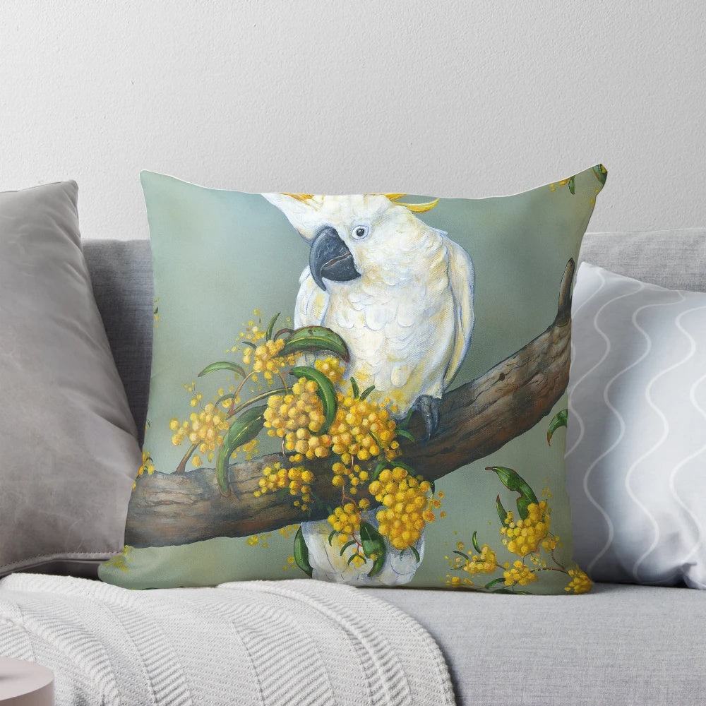 Closeup image of a beautiful Australian white cockatoo perched on a decorative pillow